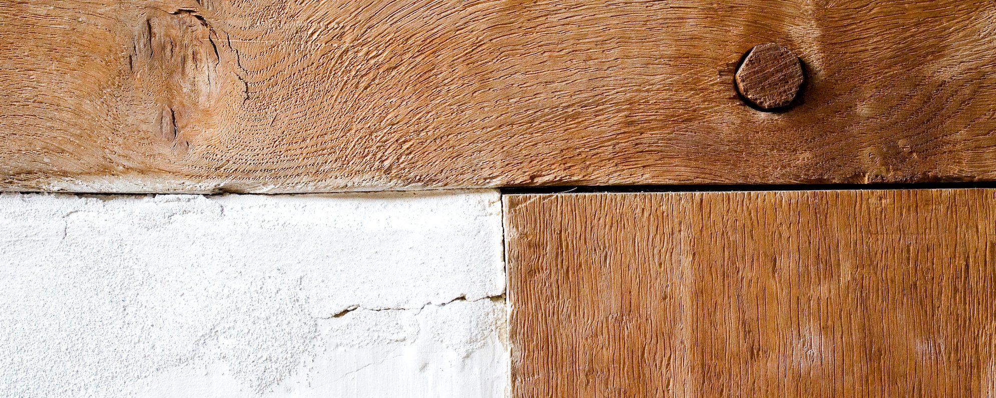 FAQs Frequently Asked Questions A close up of a wooden frame on a building