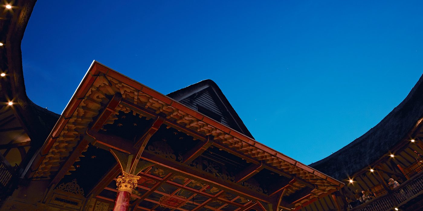Globe Theatre blue sky Shakespeare's Globe A bright blue evening sky above a circular timber theatre, with pointed thatched roof.
