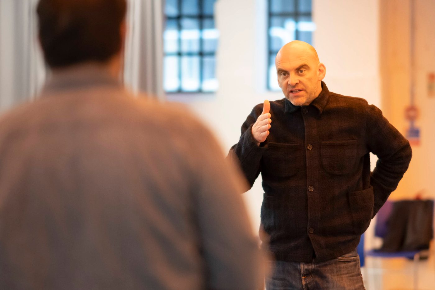 Hamlet A director speaks to an actor who has his back facing the camera