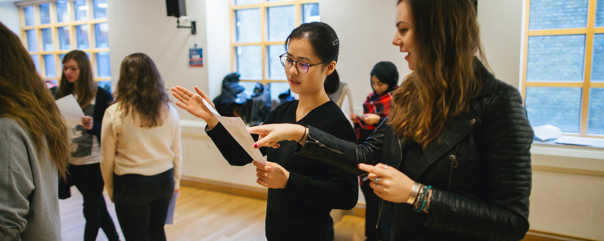 Higher Education Masthead Students read from a script