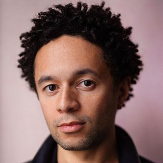 This is a headshot of Michael Abubakar looking directly to camera.