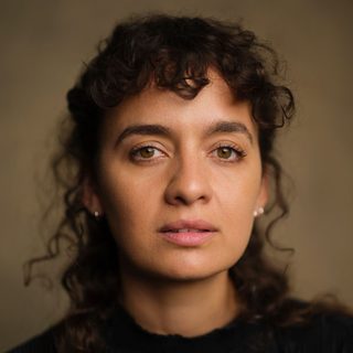 This is a headshot of Nadi Kemp-Sayfi  looking directly to camera.