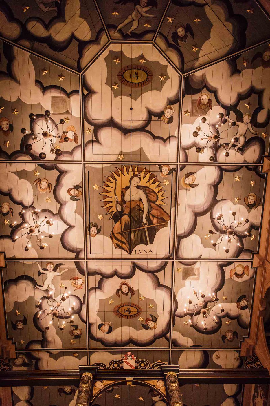 Sam Wanamaker Playhouse Ceiling An intricately painted ceiling, looking up at it from below, with illustrations of clouds and angels
