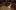 Sam Wanamaker Playhouse Recording Studio Blog An empty indoor stage of a theatre with a large, black candelabra dangling from above