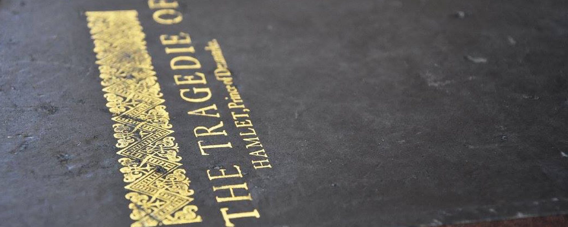 Discover Shakespeare’s Plays Masthead A black book with a gold title on it which reads The Tragedie of Hamlet of Denmark