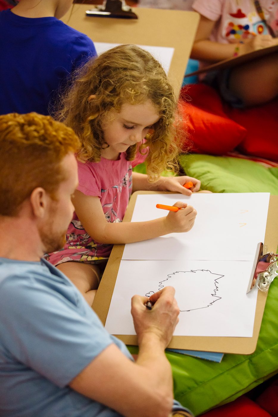 Teaching Resources Shakespeare’s Globe An adult and a child draw on pieces of paper together