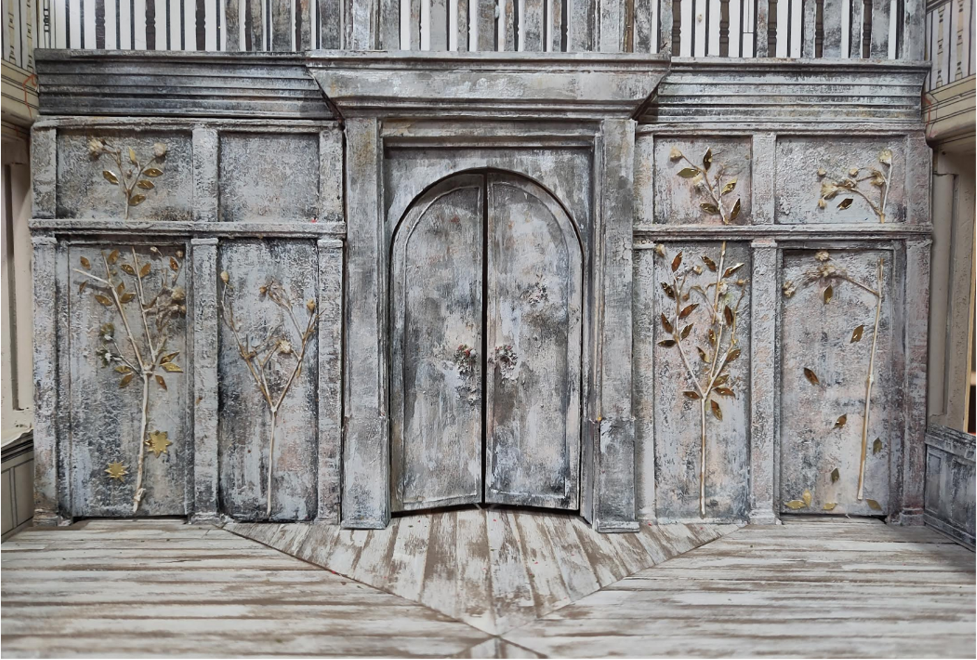Set design of Three Sisters on a model box. Close-up of the set design of Three Sisters on a model box. The model shows the back wall of the stage, which has been clad with silver birch and adorned with trees picked out in gold relief.