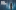 MOREGhostStories_Social_Website_V3_AWK_1600 x 1000_01 'More...Ghost Stories' show artwork depicts the black silhouette of a woman facing into a foggy, dark-blue forest is created by the halo of a distant light. In the top left corner, a white block-letter title reads ‘MORE…GHOST STORIES by Candlelight’.